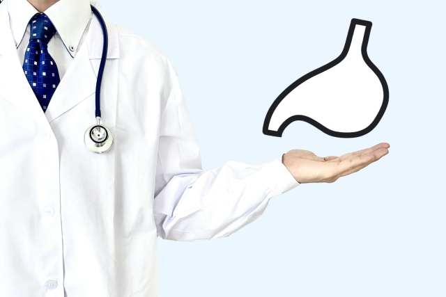 胃のイラストと白衣の男性